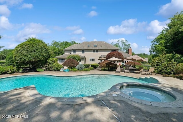 9 Wide Horizons Dr, Colts Neck, NJ 07722 - view of pool featuring a patio, a pool with connected hot tub, and view of scattered trees