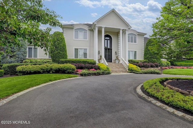 7 Rancho Polo, Colts Neck, NJ 07722 - neoclassical / greek revival house featuring stucco siding, a front lawn, and asphalt driveway