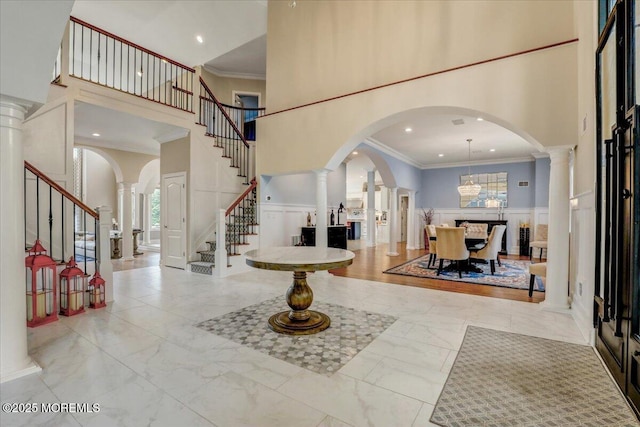 7 Rancho Polo, Colts Neck, NJ 07722 - foyer entrance with a high ceiling, decorative columns, crown molding, stairway, and a decorative wall