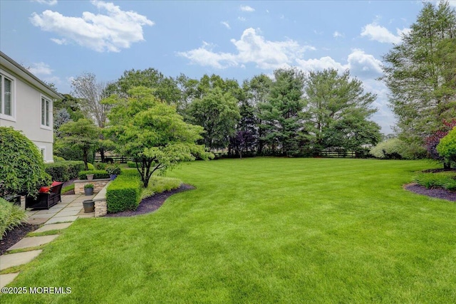 7 Rancho Polo, Colts Neck, NJ 07722 - view of green lawn featuring a patio area and view of wooded area
