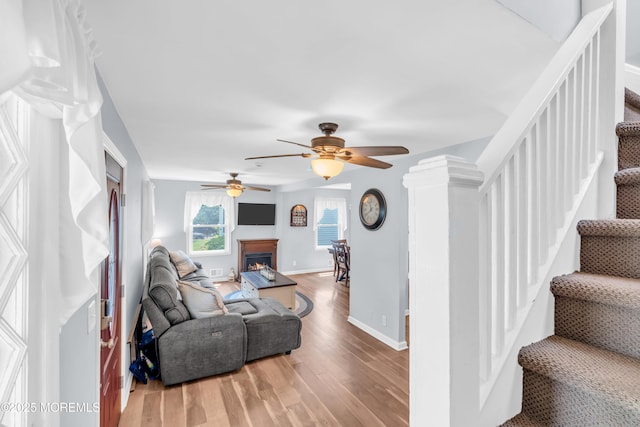 502 Corlies Ave, West Allenhurst, NJ 07711 - living area featuring a ceiling fan, wood finished floors, stairway, and a lit fireplace