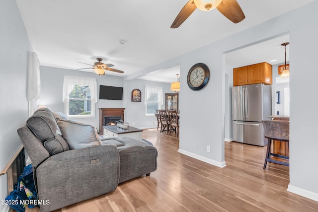 502 Corlies Ave, West Allenhurst, NJ 07711 - living room with ceiling fan, light wood-style flooring, and a warm lit fireplace