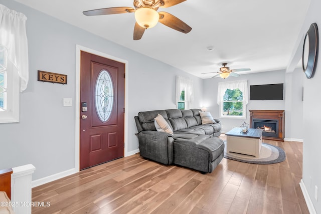 502 Corlies Ave, West Allenhurst, NJ 07711 - living room featuring a ceiling fan, light wood-type flooring, and a lit fireplace