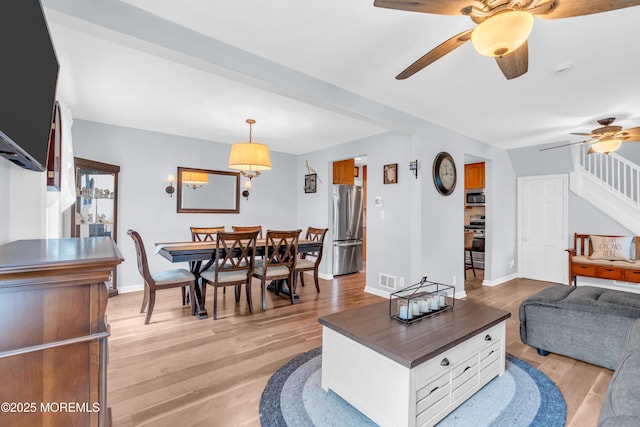 502 Corlies Ave, West Allenhurst, NJ 07711 - living area featuring a ceiling fan, light wood finished floors, and stairs