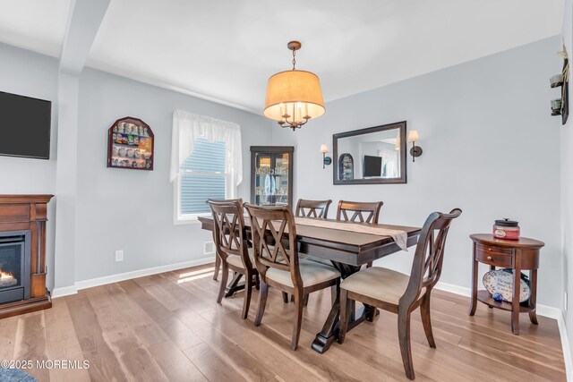 502 Corlies Ave, West Allenhurst, NJ 07711 - dining area featuring light wood finished floors and a warm lit fireplace