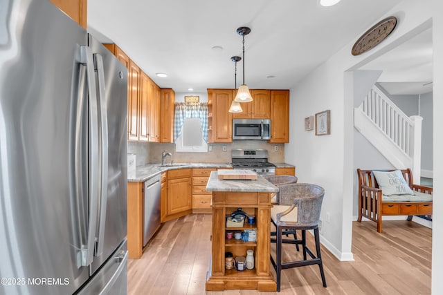 502 Corlies Ave, West Allenhurst, NJ 07711 - kitchen with stainless steel appliances, a center island, light wood-type flooring, open shelves, and decorative backsplash