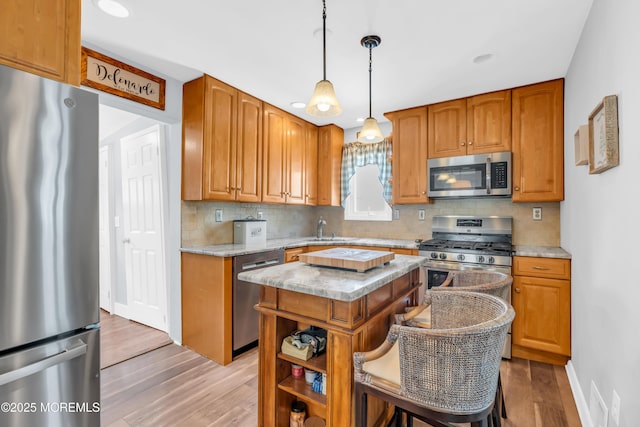 502 Corlies Ave, West Allenhurst, NJ 07711 - kitchen with stainless steel appliances, light wood-type flooring, decorative backsplash, and a center island