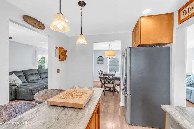 502 Corlies Ave, West Allenhurst, NJ 07711 - kitchen with freestanding refrigerator, light wood-style flooring, decorative light fixtures, open floor plan, and light stone counters
