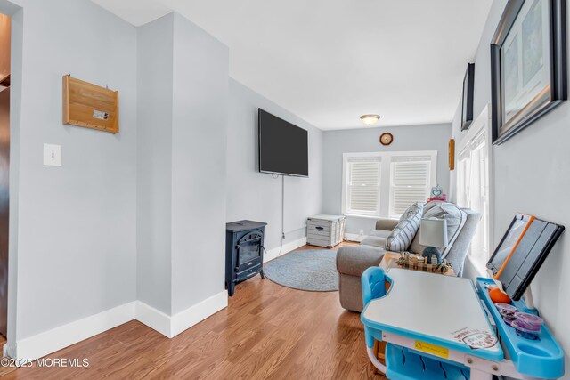 502 Corlies Ave, West Allenhurst, NJ 07711 - living area with a wood stove and light wood-style flooring