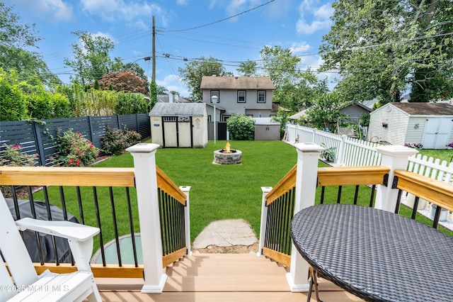 502 Corlies Ave, West Allenhurst, NJ 07711 - wooden deck featuring a storage unit, a fenced backyard, and a fire pit