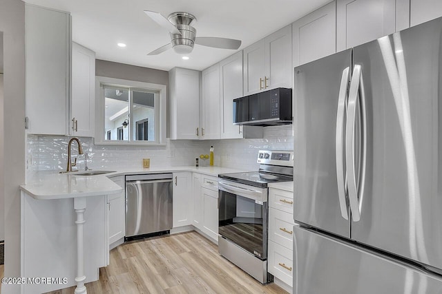 51 Hiering Ave Unit D4, Seaside Heights, NJ 08751 - kitchen featuring appliances with stainless steel finishes, a ceiling fan, light wood finished floors, tasteful backsplash, and recessed lighting