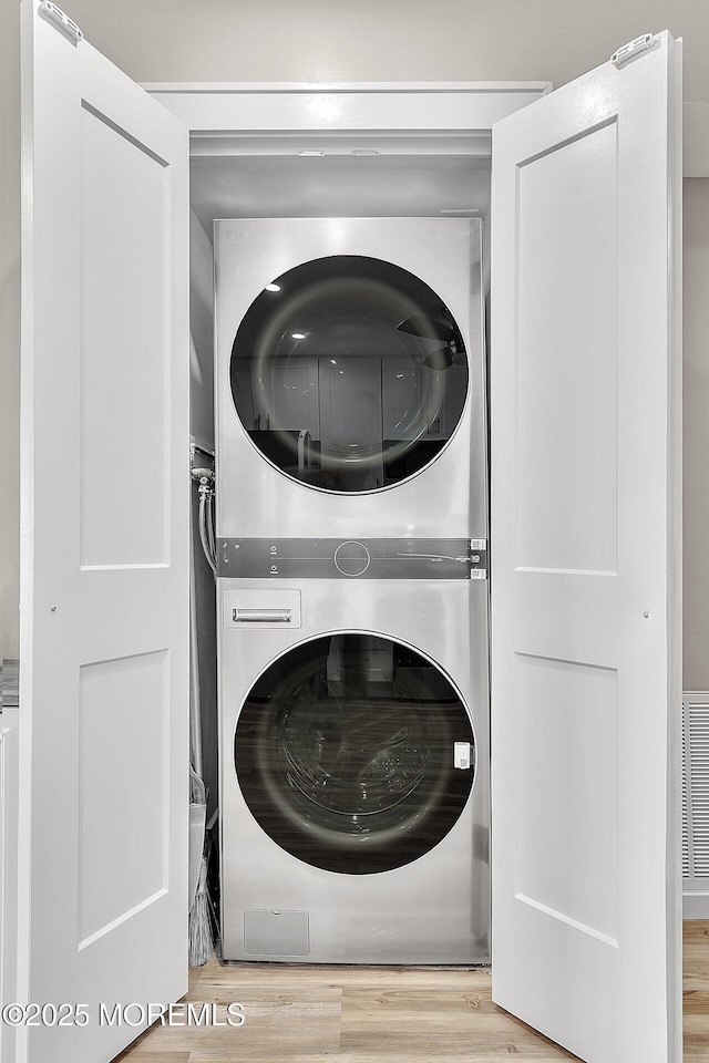 51 Hiering Ave Unit D4, Seaside Heights, NJ 08751 - washroom with stacked washer / dryer and wood finished floors