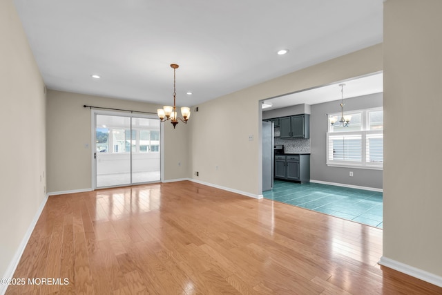 28 Greenbriar Blvd, Brick, NJ 08724 - unfurnished living room featuring a chandelier, light wood-style flooring, healthy amount of natural light, and recessed lighting