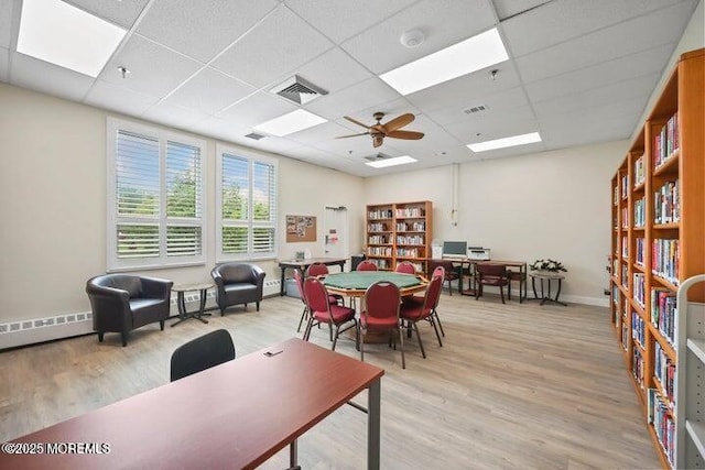 28 Greenbriar Blvd, Brick, NJ 08724 - dining area with a paneled ceiling, light wood-style flooring, a ceiling fan, and a baseboard heating unit