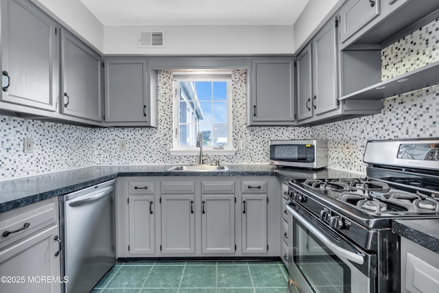 28 Greenbriar Blvd, Brick, NJ 08724 - kitchen featuring stainless steel appliances, dark countertops, tile patterned floors, and tasteful backsplash
