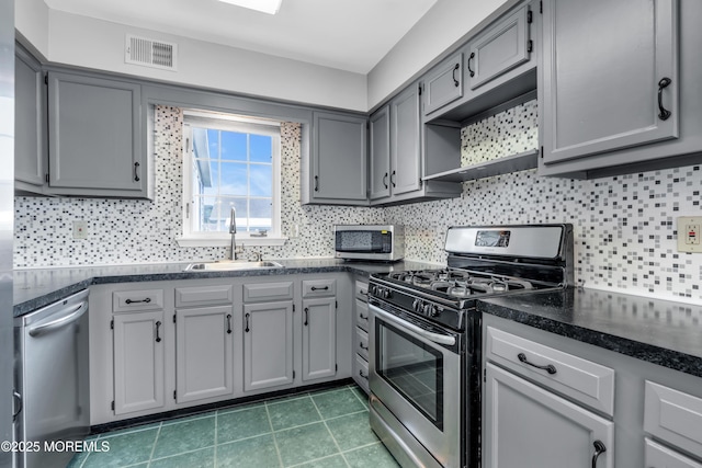 28 Greenbriar Blvd, Brick, NJ 08724 - kitchen with stainless steel appliances, gray cabinets, and decorative backsplash