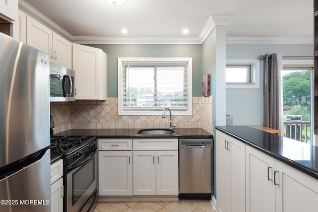 1641 Elm Ave Unit 10, Point Pleasant, NJ 08742 - kitchen featuring appliances with stainless steel finishes, dark countertops, backsplash, crown molding, and white cabinets