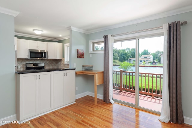 1641 Elm Ave Unit 10, Point Pleasant, NJ 08742 - kitchen featuring appliances with stainless steel finishes, a water view, tasteful backsplash, white cabinets, and dark countertops