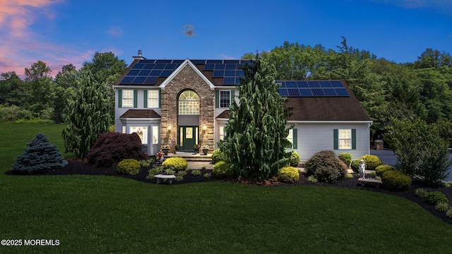 32 Langeveld Dr, Freehold, NJ 07728 - view of front facade with a yard and roof mounted solar panels