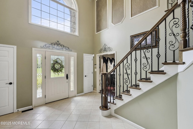 32 Langeveld Dr, Freehold, NJ 07728 - foyer entrance featuring healthy amount of natural light, a towering ceiling, tile patterned floors, and stairs
