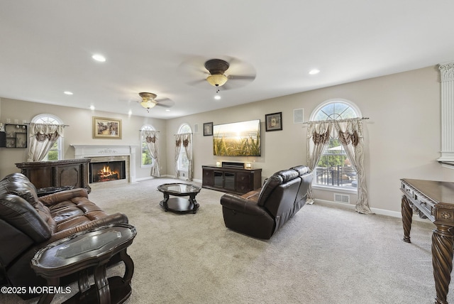32 Langeveld Dr, Freehold, NJ 07728 - living room featuring a ceiling fan, carpet, plenty of natural light, a warm lit fireplace, and recessed lighting