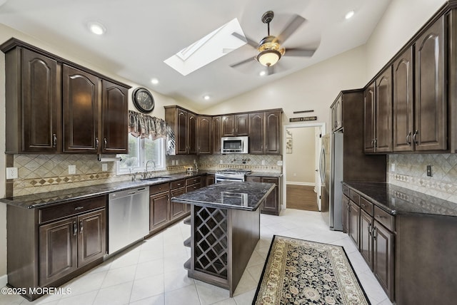 32 Langeveld Dr, Freehold, NJ 07728 - kitchen featuring appliances with stainless steel finishes, a skylight, vaulted ceiling, a ceiling fan, and dark brown cabinetry