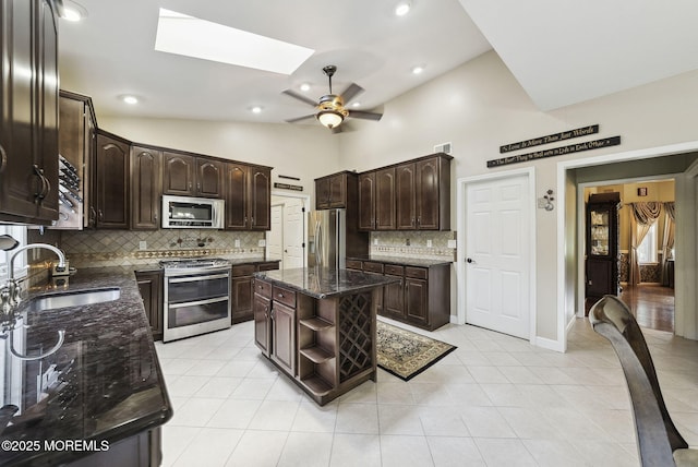 32 Langeveld Dr, Freehold, NJ 07728 - kitchen with appliances with stainless steel finishes, dark brown cabinets, tasteful backsplash, dark stone counters, and ceiling fan