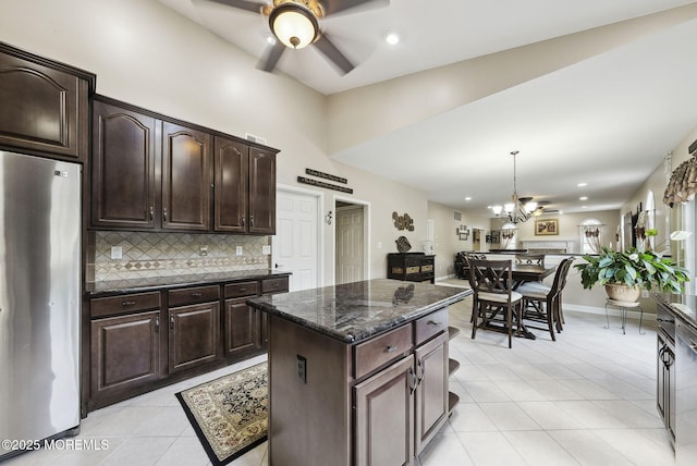 32 Langeveld Dr, Freehold, NJ 07728 - kitchen with stainless steel appliances, light tile patterned floors, a ceiling fan, backsplash, and a chandelier