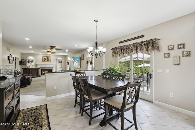 32 Langeveld Dr, Freehold, NJ 07728 - dining room with ceiling fan, light tile patterned flooring, a lit fireplace, recessed lighting, and a chandelier