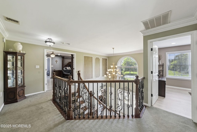 32 Langeveld Dr, Freehold, NJ 07728 - hallway with an upstairs landing, a chandelier, carpet floors, and ornamental molding