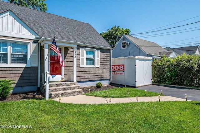 296 High St, Metuchen, NJ 08840 - view of front of home with a shingled roof, a front yard, and board and batten siding