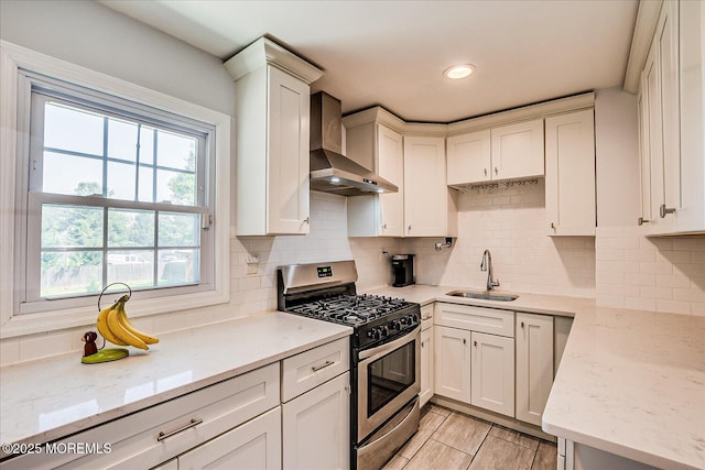 296 High St, Metuchen, NJ 08840 - kitchen featuring stainless steel gas range, wall chimney exhaust hood, light stone countertops, tasteful backsplash, and recessed lighting