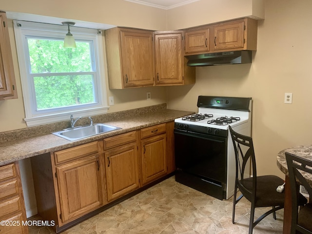 97 Vine St, Bayville, NJ 08721 - kitchen with under cabinet range hood, gas range oven, ornamental molding, and brown cabinets