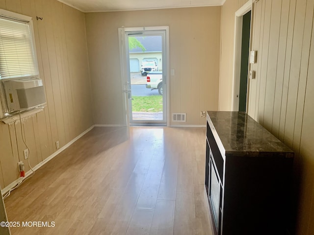 97 Vine St, Bayville, NJ 08721 - unfurnished dining area with light wood finished floors, cooling unit, and wood walls
