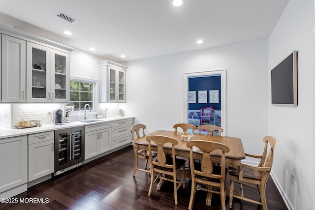 12 Linda Ln, Tinton Falls, NJ 07724 - dining room with beverage cooler, dark wood finished floors, and recessed lighting