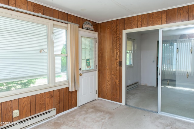 30 Sherwood Ln, Toms River, NJ 08757 - doorway to outside with a baseboard radiator, wooden walls, plenty of natural light, light colored carpet, and crown molding