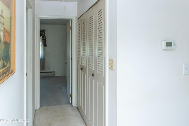 30 Sherwood Ln, Toms River, NJ 08757 - corridor featuring a baseboard heating unit, unfinished concrete flooring, and attic access
