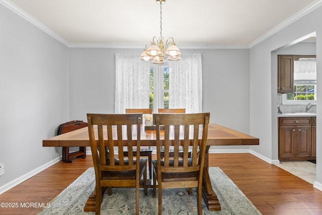 3 Thompson Ln, Manalapan, NJ 07726 - dining room with a chandelier, light wood-type flooring, and crown molding