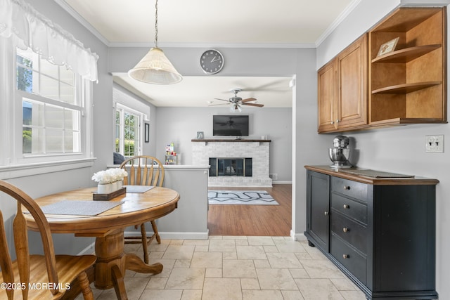 3 Thompson Ln, Manalapan, NJ 07726 - kitchen featuring a ceiling fan, brown cabinetry, open shelves, crown molding, and a fireplace