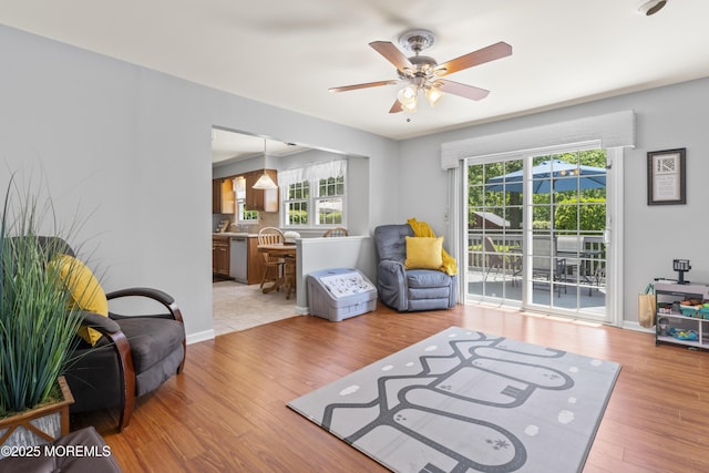 3 Thompson Ln, Manalapan, NJ 07726 - living room with healthy amount of natural light, ceiling fan, and light wood finished floors