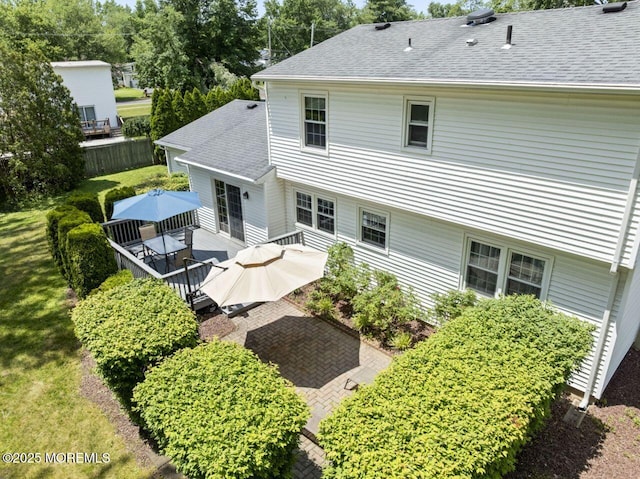 3 Thompson Ln, Manalapan, NJ 07726 - rear view of house featuring a shingled roof, a wooden deck, outdoor dining space, and a patio area