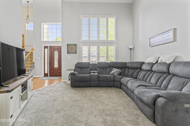 734 S River Dr, Forked River, NJ 08731 - living room featuring a towering ceiling, stairs, and carpet floors