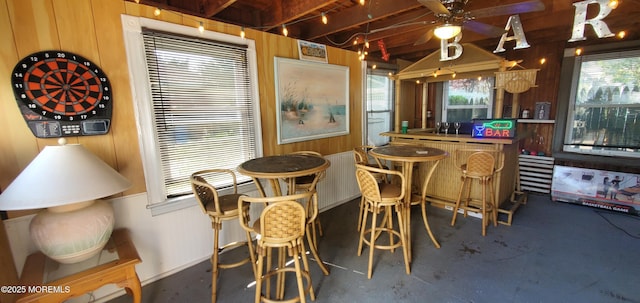 412 Park Place Ave, Bradley Beach, NJ 07720 - dining area with ceiling fan, wooden walls, healthy amount of natural light, concrete floors, and beam ceiling