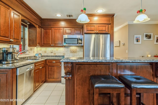 1111 Wellington Pl, Matawan, NJ 07747 - kitchen featuring stainless steel appliances, ornamental molding, backsplash, decorative light fixtures, and dark stone counters