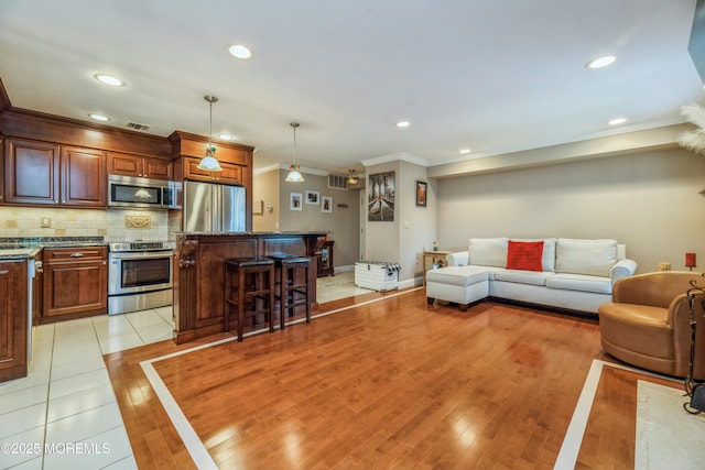 1111 Wellington Pl, Matawan, NJ 07747 - living area featuring ornamental molding, recessed lighting, and light wood-type flooring