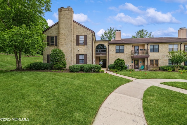 1111 Wellington Pl, Matawan, NJ 07747 - view of front facade featuring a chimney, a front lawn, and a balcony
