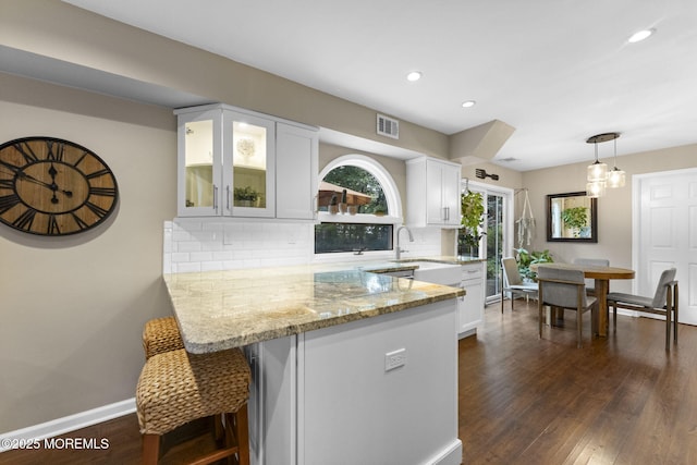 280 Double Creek Pkwy, Freehold, NJ 07728 - kitchen featuring white cabinets, light stone counters, glass insert cabinets, backsplash, and recessed lighting