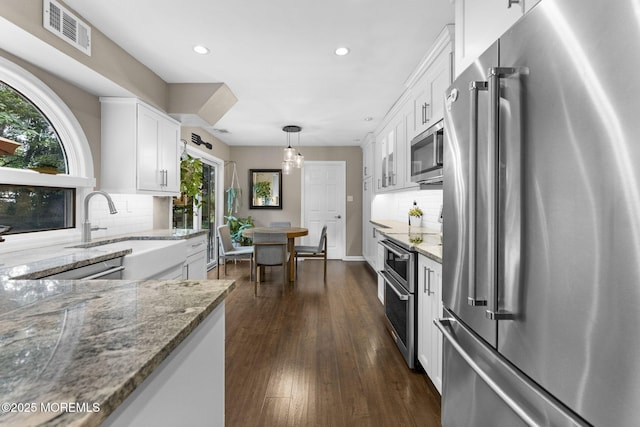 280 Double Creek Pkwy, Freehold, NJ 07728 - kitchen featuring appliances with stainless steel finishes, white cabinets, light stone countertops, recessed lighting, and backsplash