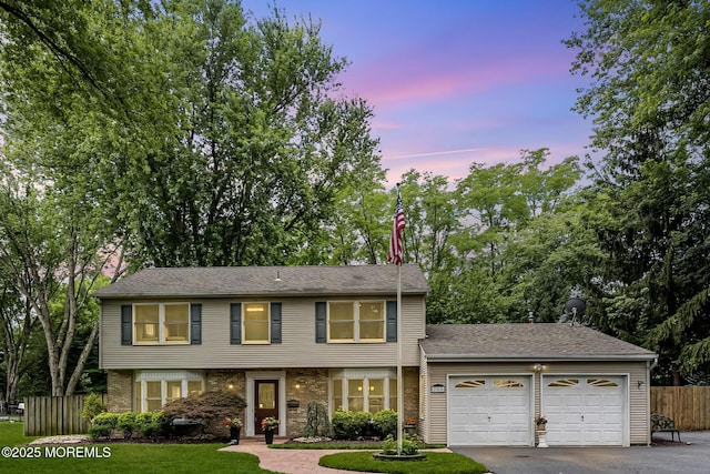 280 Double Creek Pkwy, Freehold, NJ 07728 - view of front of home featuring an attached garage, driveway, brick siding, and view of scattered trees