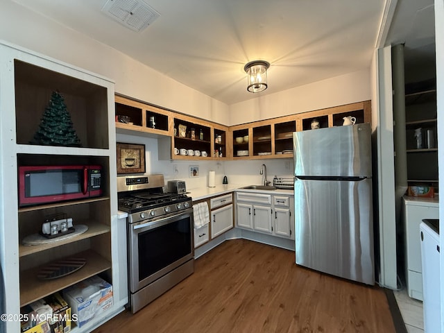 4 Nebraska Dr Unit C, Matawan, NJ 07747 - kitchen with appliances with stainless steel finishes, open shelves, dark wood-style flooring, light countertops, and washer / clothes dryer